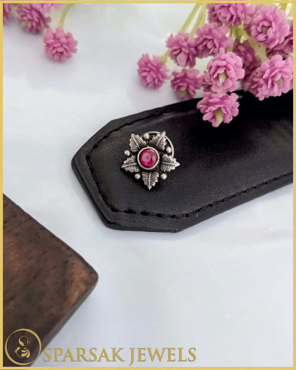 Silver temple nosepin with intricate design on white background