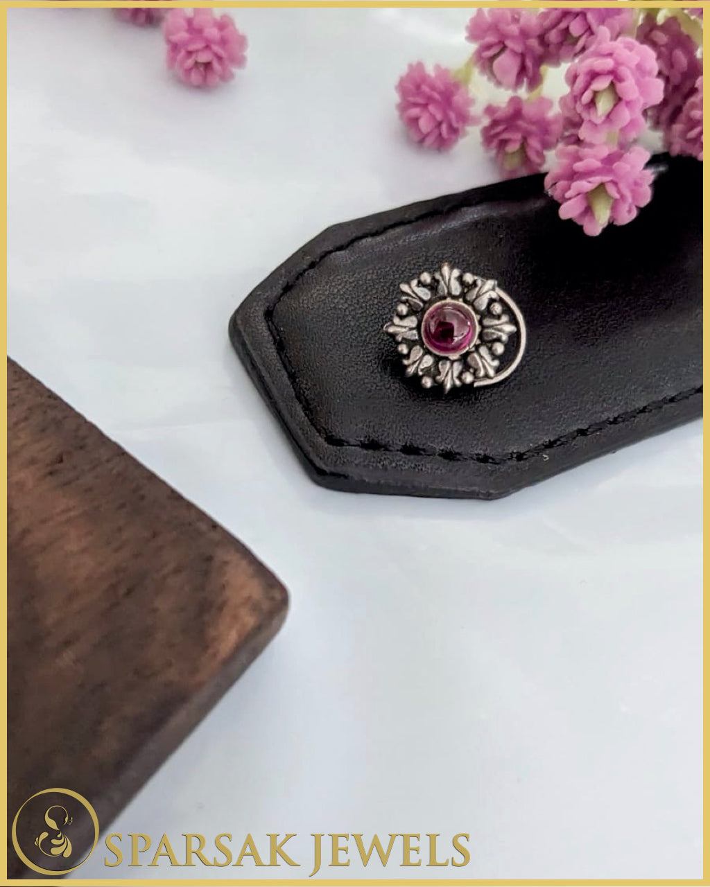 Silver temple nosepin with delicate filigree work on marble background