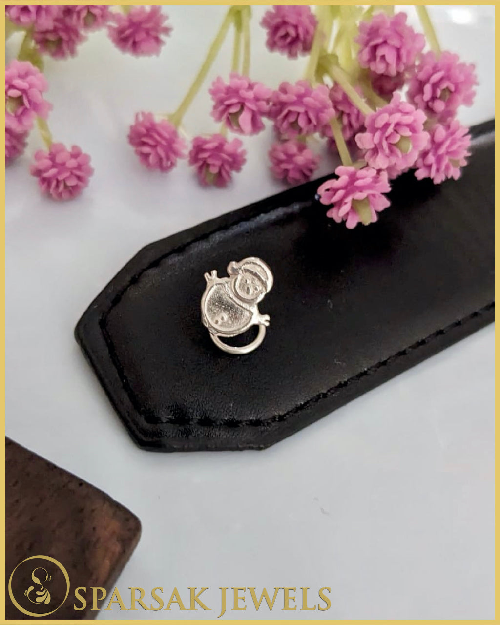 Graceful silver temple nosepin with filigree work on marble background