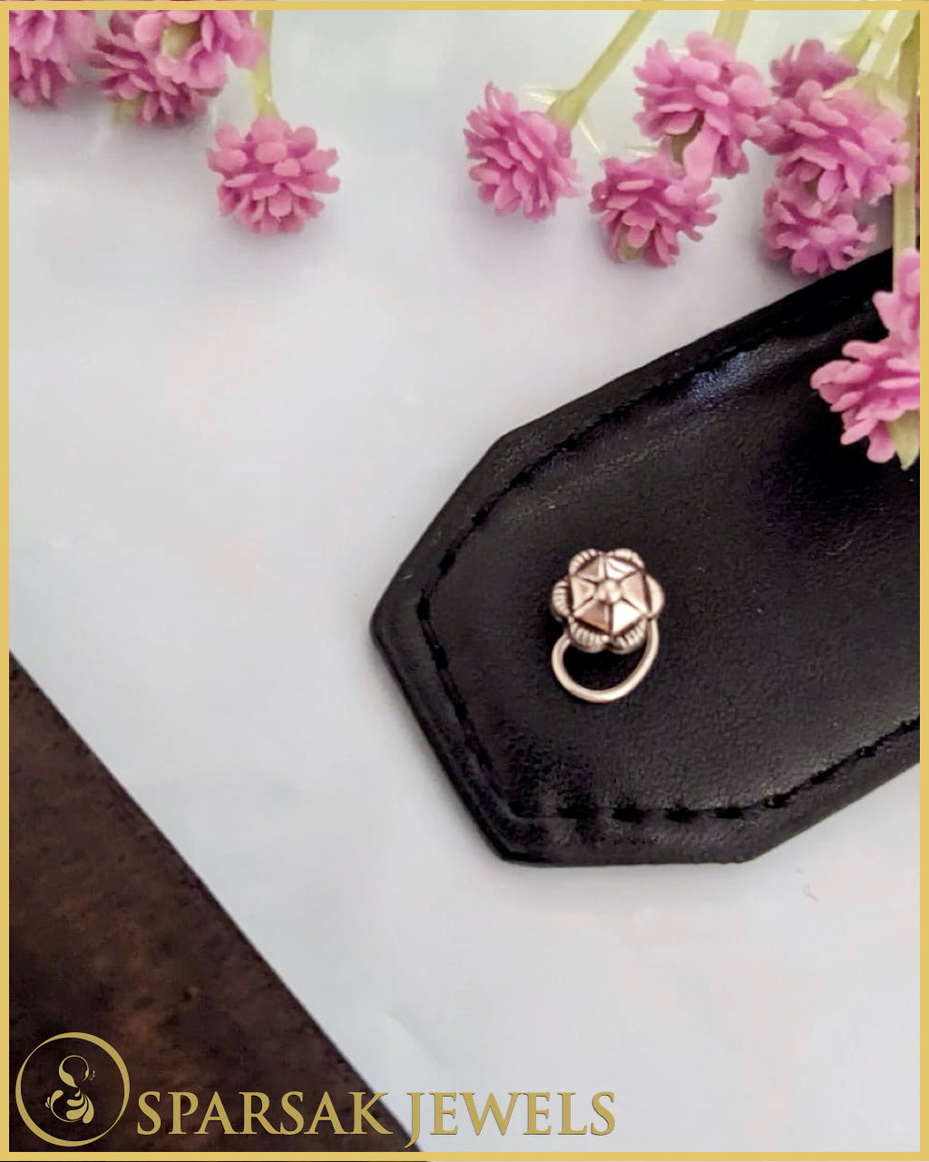 Silver temple nosepin with artisan craftsmanship on blue background