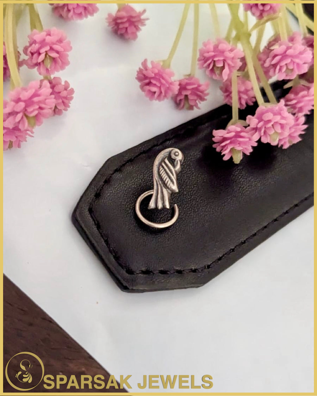 Graceful silver temple nosepin with filigree work on marble background