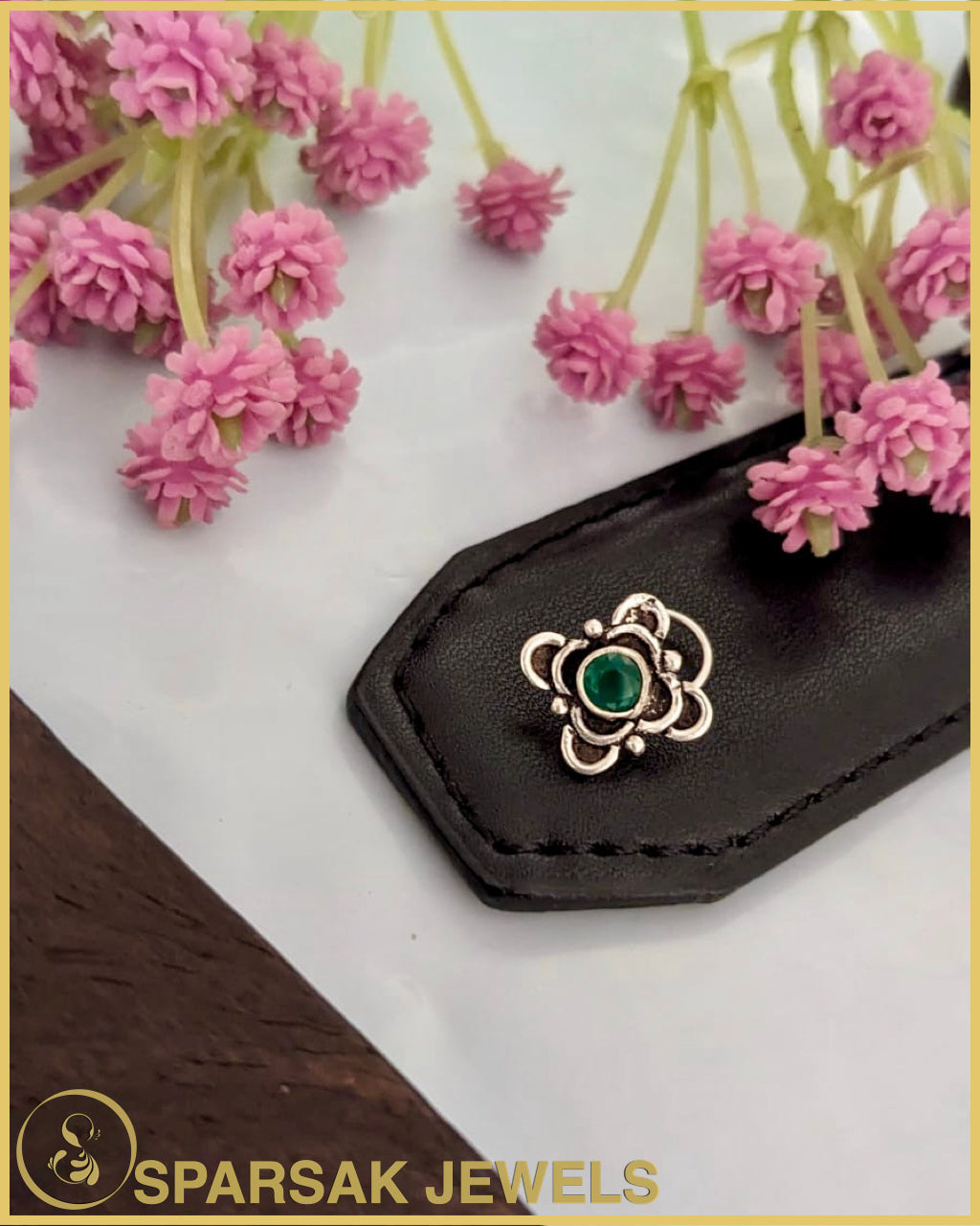 Silver temple nosepin with detailed engraving on black background