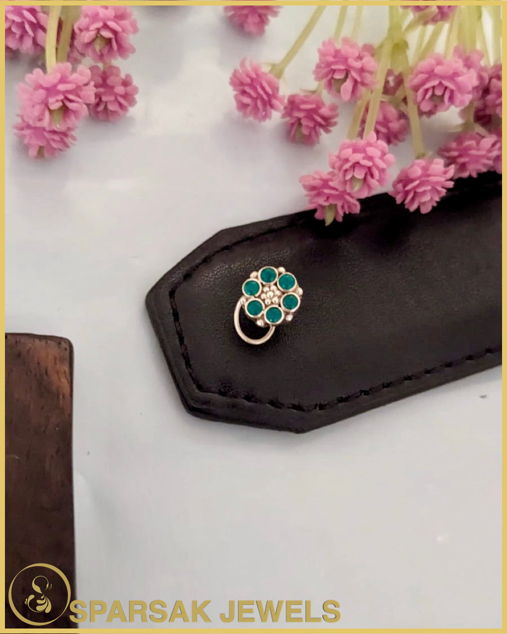 Silver temple nosepin with detailed engraving on black background