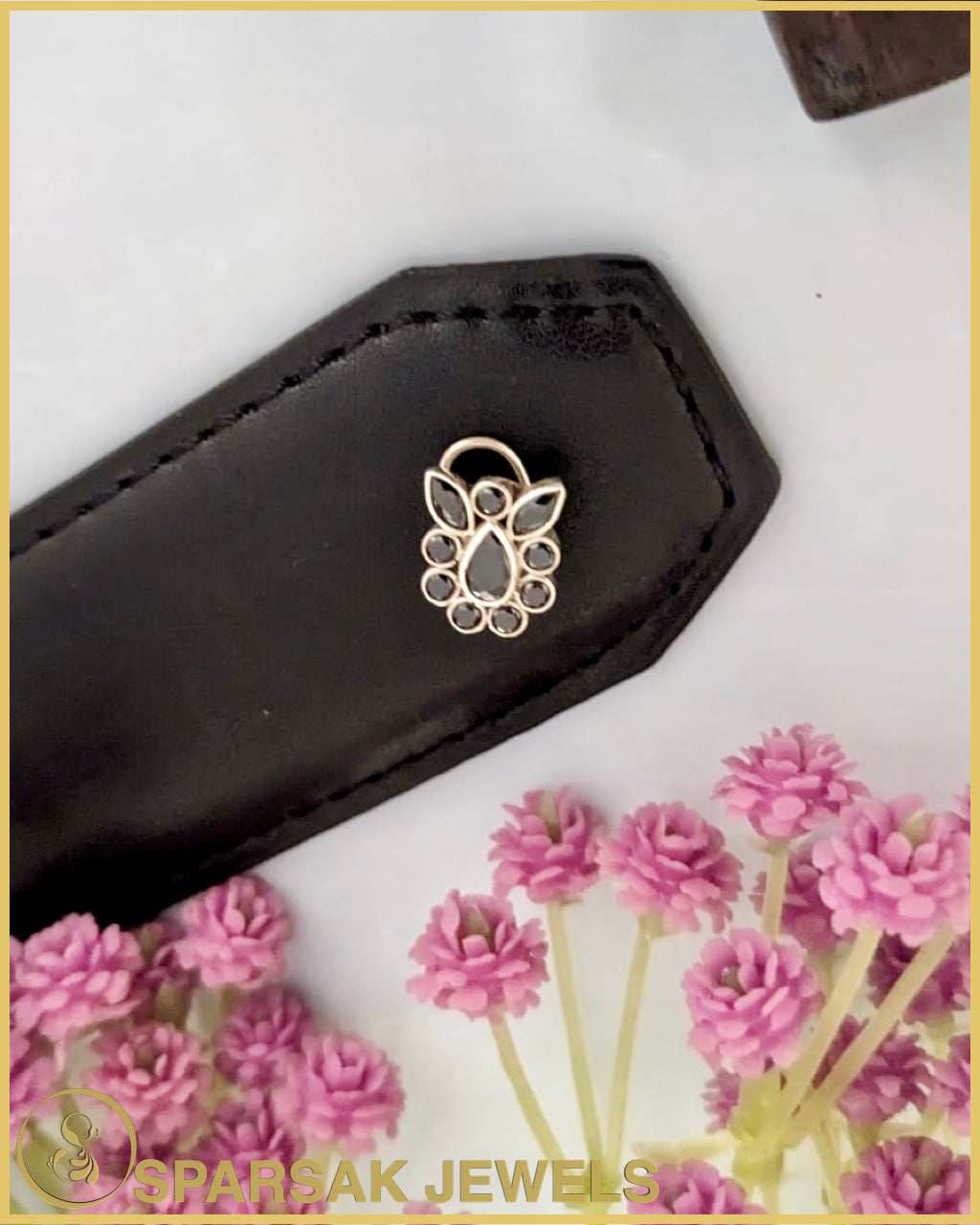 Silver temple nosepin with intricate design on white background