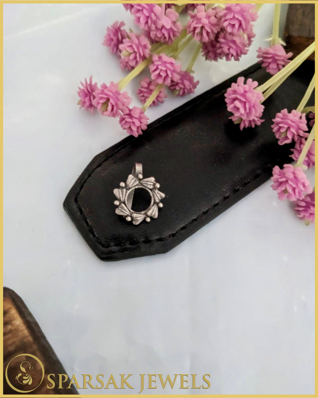 Exquisite silver temple nosepin with floral motifs on pink background