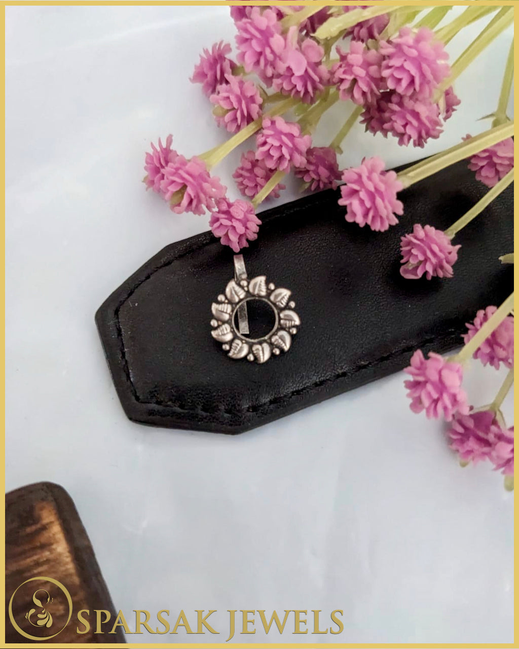 Silver temple nosepin with intricate design on white background