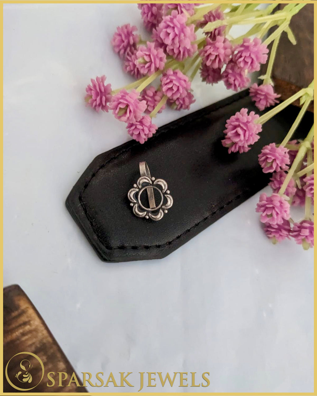 Silver temple nosepin with delicate filigree work on marble background