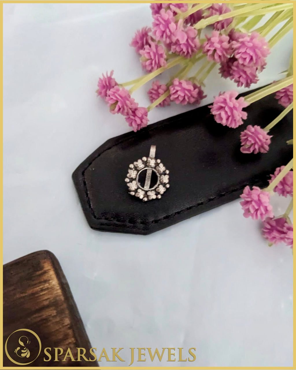 Silver temple nosepin with artisan craftsmanship on blue background