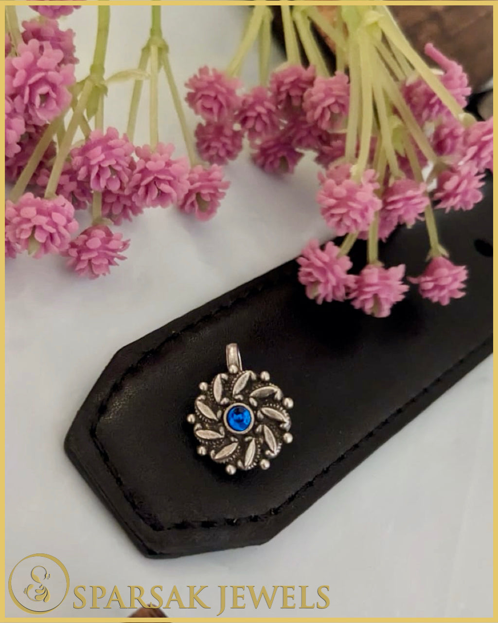 Silver temple nosepin with intricate design on white background