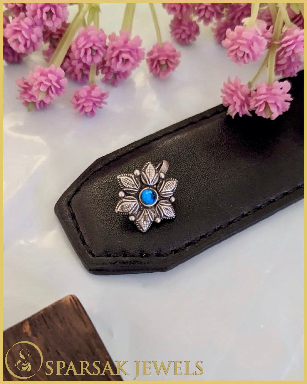 Graceful silver temple nosepin with filigree work on marble background