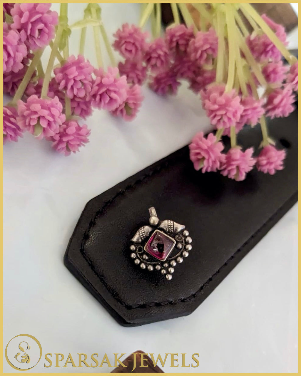 Silver temple nosepin with intricate design on white background