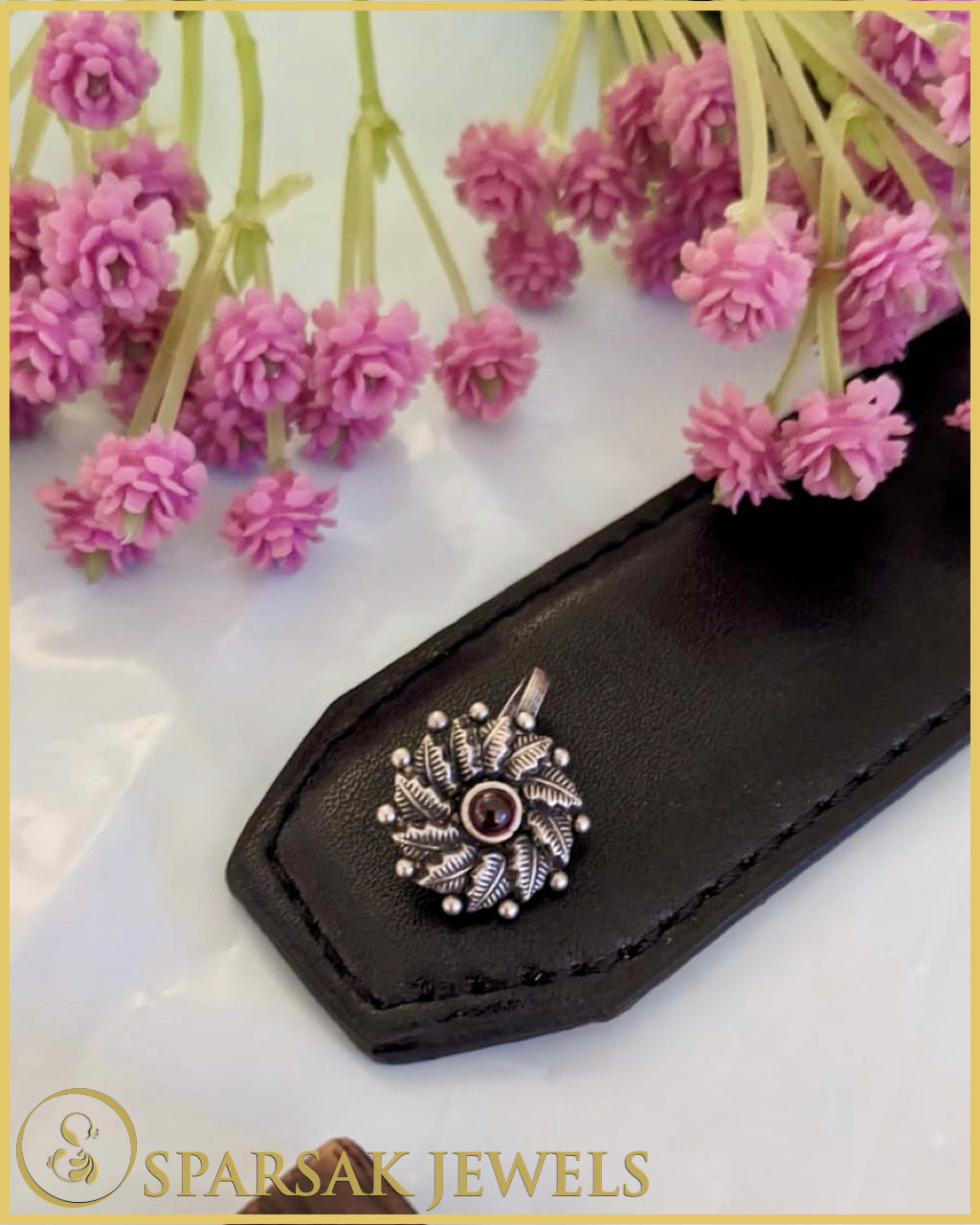 Silver temple nosepin with classic design on pink background