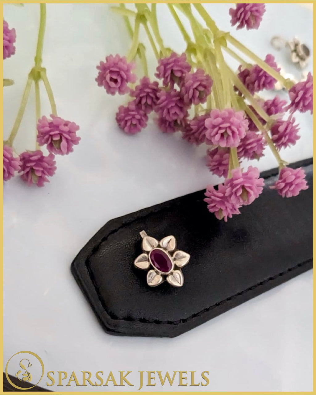 Silver temple nosepin with intricate design on white background