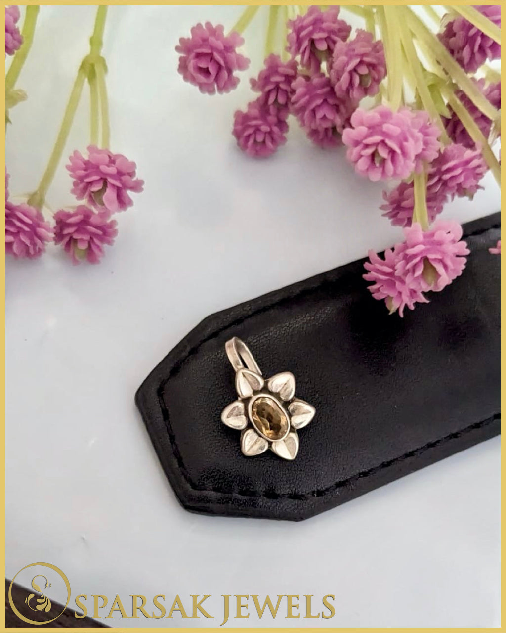 Classic silver temple nosepin with intricate detailing on blue background