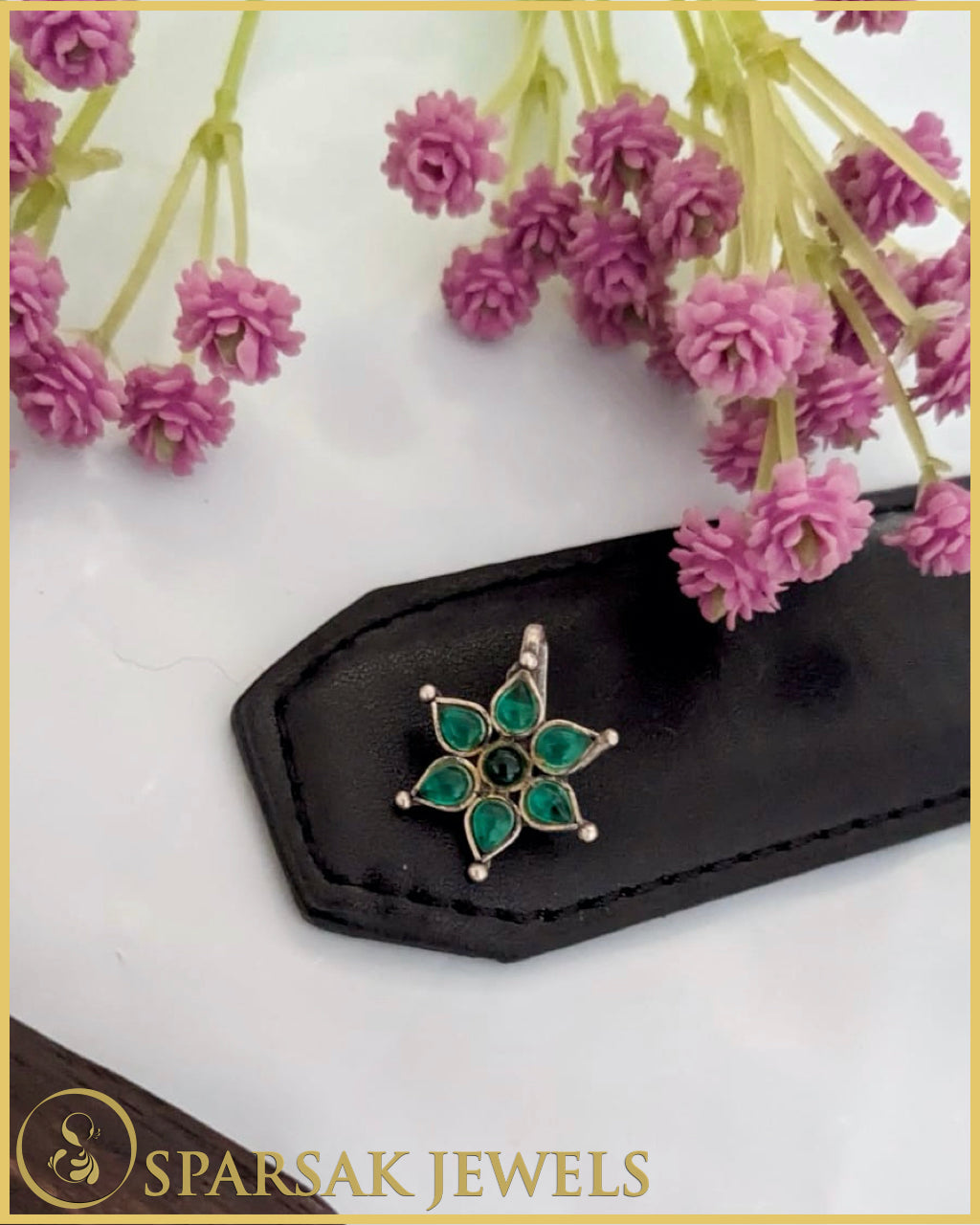 Silver temple nosepin with intricate design on white background