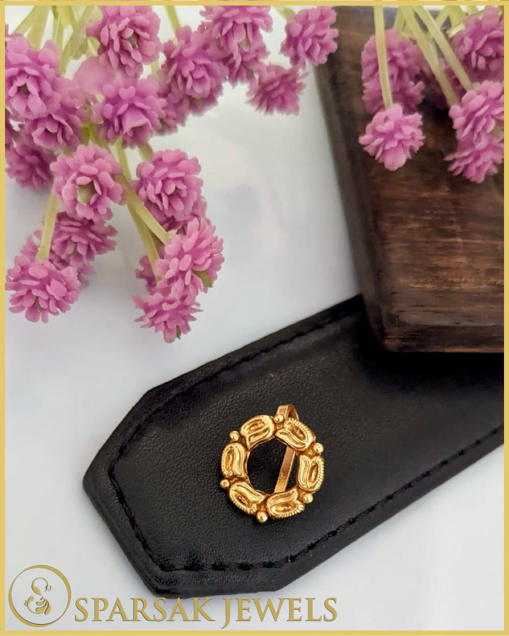 Silver temple nosepin with delicate filigree work on marble background