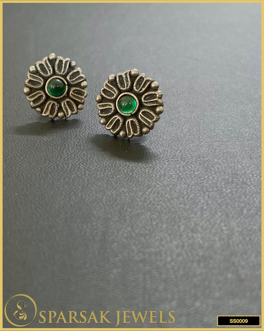 Silver temple stud earrings with intricate patterns on white background.