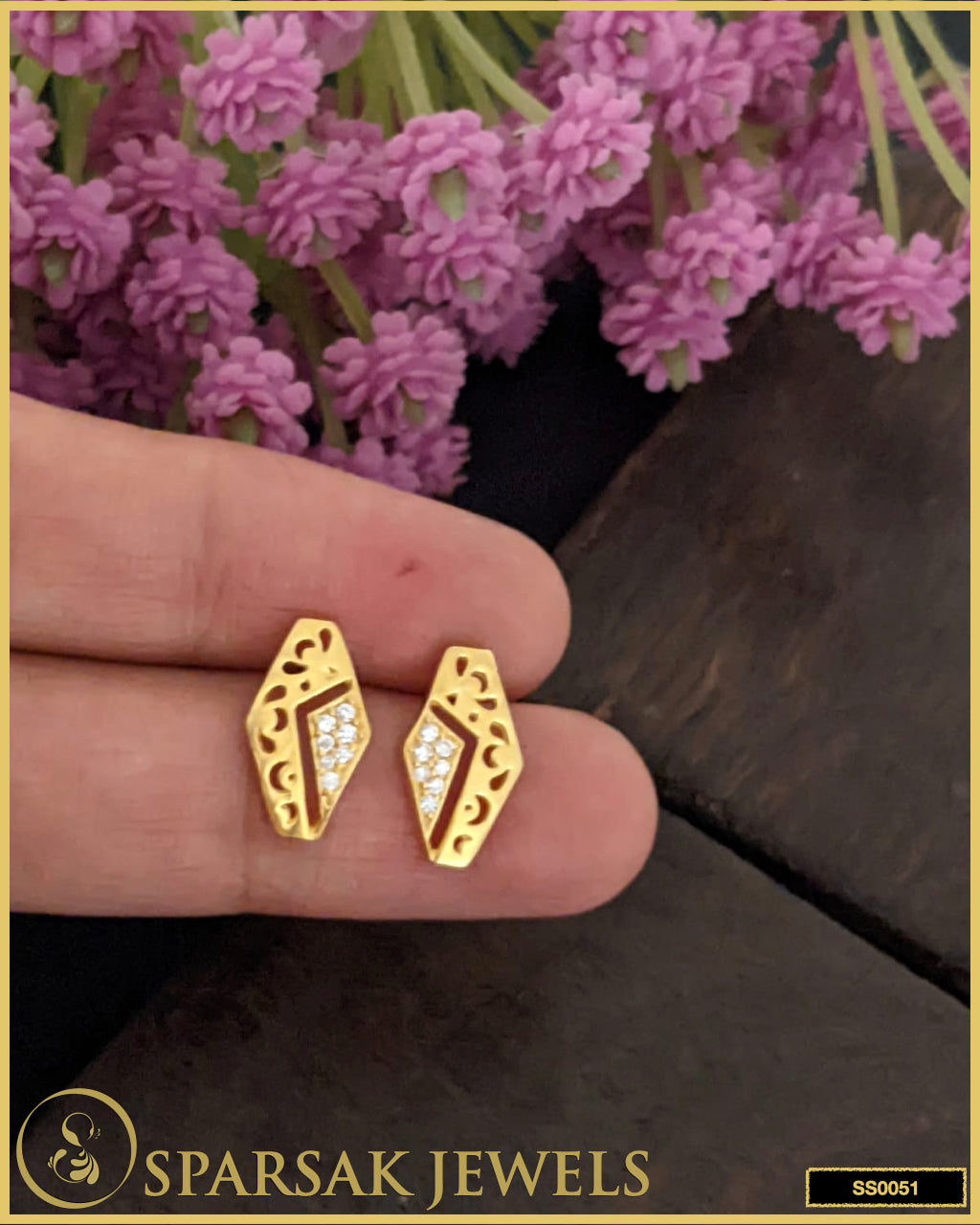 Gold-polished silver earrings studs with intricate design on white background.