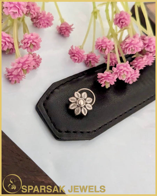 Classic silver temple nosepin with intricate detailing on blue background