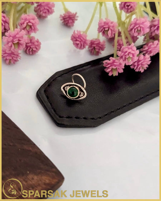 Silver temple nosepin with intricate design on white background