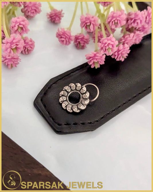 Silver temple nosepin with delicate filigree work on marble background