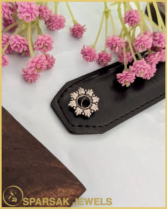 Silver temple nosepin with artisan craftsmanship on blue background