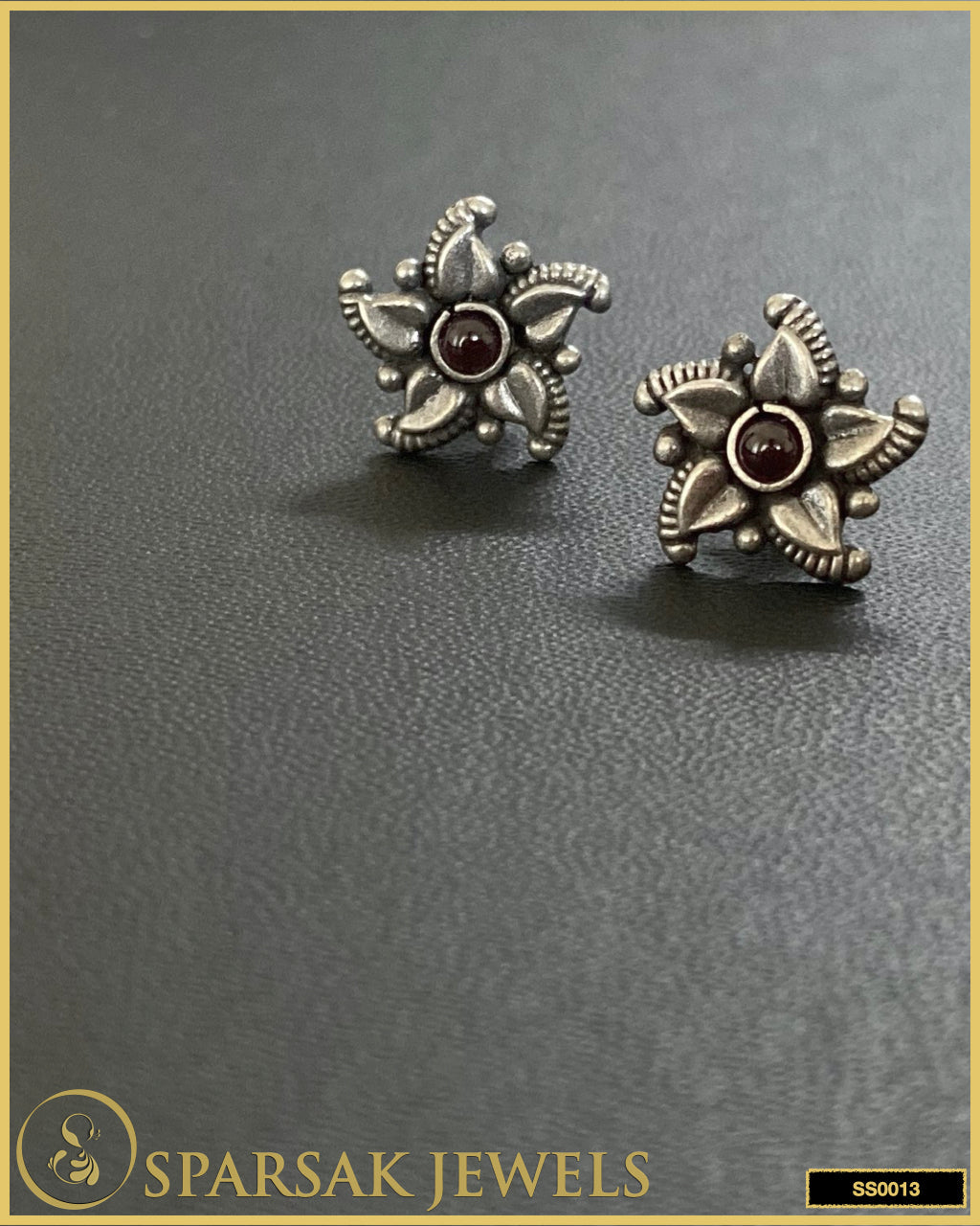 Exquisite silver temple earrings studs on black background.