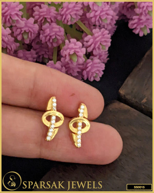 Gold-polished silver earrings studs with intricate design on white background.