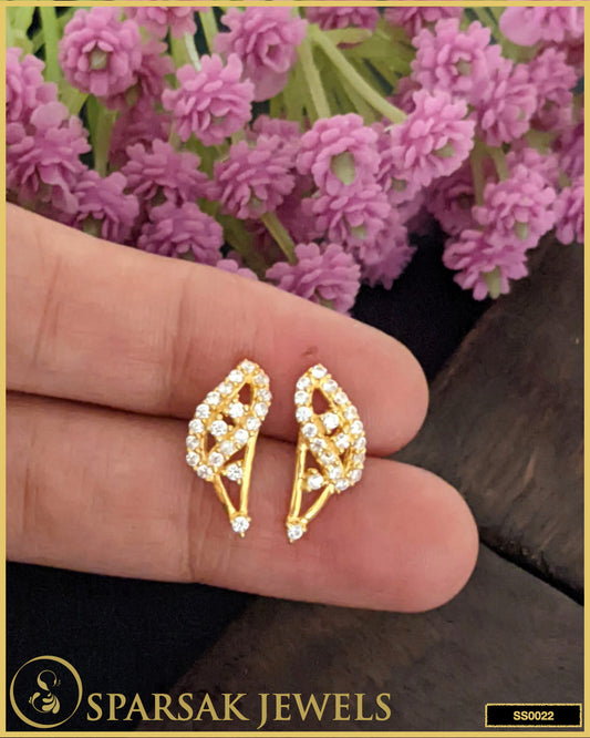 Gold-polished small silver stud earrings with intricate design on white background.