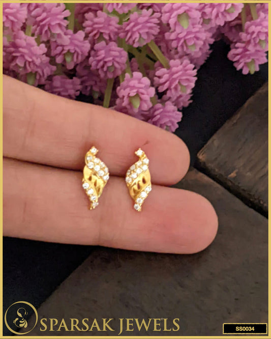 Gold-polished small silver stud earrings with delicate design on white background.