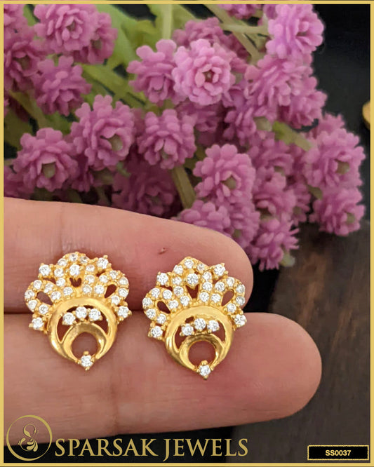 Gold-polished small silver stud earrings with subtle glamour design on white background.